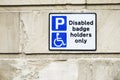 Disabled Badge Holders Only at Car Park Sign on Wall Royalty Free Stock Photo