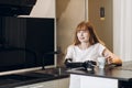 Disabled beautiful girl drinking tea in the kitchen