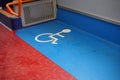 Disabled blue and white sign on floor of a public transport bus
