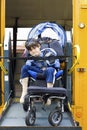 Disabled boy on school bus wheelchair lift Royalty Free Stock Photo