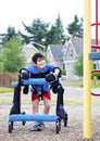 Disabled boy in walker at inaccessible pla Royalty Free Stock Photo