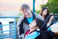 Disabled boy in wheelchair enjoying watching friends play at par Royalty Free Stock Photo