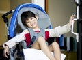 Disabled boy in wheelchair opening door Royalty Free Stock Photo