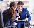 Disabled businessman having discussion with female colleague Royalty Free Stock Photo