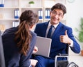 Disabled businessman having discussion with female colleague Royalty Free Stock Photo