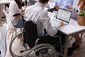 Disabled Businessman Sitting On Wheelchair Using Laptop Royalty Free Stock Photo