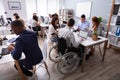 Disabled Businessman Sitting On Wheelchair Using Laptop Royalty Free Stock Photo