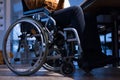 Disabled businessman in the wheelchair works in the office at the computer while performing in co-working space. Disability and