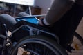 Disabled businessman in the wheelchair works in the office at the computer while performing in co-working space. Disability and