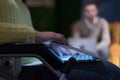 Disabled businesswoman in the wheelchair using her laptop while performing in co-working space. Disability and handicap concept. Royalty Free Stock Photo