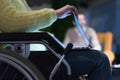 Disabled businesswoman in the wheelchair using her laptop while performing in co-working space. Disability and handicap concept. Royalty Free Stock Photo