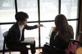 Disabled businesswoman working with her colleague in workplace. Royalty Free Stock Photo