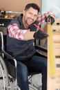 disabled carpenter in wheelchair smiling Royalty Free Stock Photo