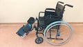 Disabled carriage. Black wheelchair in the hospital for the transportation of seriously ill people