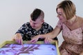 disabled child doing sensory activity with sand, rehabilitation