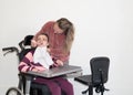 A disabled child in a wheelchair together with a voluntary care worker Royalty Free Stock Photo