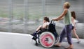 Disabled child in a wheelchair on a city street