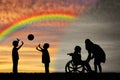 Disabled child in wheelchair crying and his mother near children play with ball Royalty Free Stock Photo