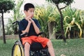 Disabled child on wheelchair with emotion in the park Royalty Free Stock Photo