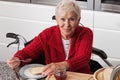 Disabled elderly in kitchen Royalty Free Stock Photo