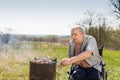 Disabled Elderly Man Grilling at the Park Alone