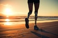 Disabled female athlete with prosthetic legs running outdoors on the beach at sunset