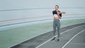 Disabled runner preparing for workout on track. Woman exercising at stadium Royalty Free Stock Photo