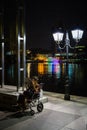 Disabled female in wheelchair reading newspaper in Singaporedisabled person