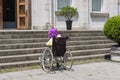 Disabled girl with purple hair in a wheelchair