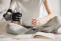 Disabled girl tries to hold a pen with an artificial arm