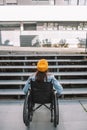 Disabled girl in wheelchair in front of the obstacle of a stair