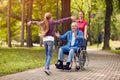 Disabled grandfather in wheelchair welcoming his granddaughter Royalty Free Stock Photo