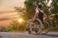 Disabled or handicapped young man on wheelchair in nature at sunset