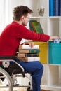 Disabled holding a book and wiped the dust Royalty Free Stock Photo