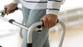 Disabled senior woman standing alone holding walking frame, close up Royalty Free Stock Photo