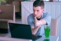 Disabled invalid man with stump hands in cafe talks on video chat on laptop. Royalty Free Stock Photo