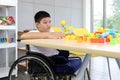 Disabled kids classroom, children having fun during study at school, kid learning and playing, schoolboy on wheelchair playing Royalty Free Stock Photo