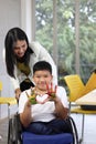 Disabled kids classroom, children having fun during study at school, kids learning together, schoolboy on wheelchair showing his Royalty Free Stock Photo