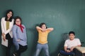 Disabled kids classroom, school boy on wheelchair and down syndrome girls learning and having fun during study at school with Royalty Free Stock Photo