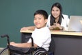 Disabled kids classroom, school boy on wheelchair with teacher, child learning and having fun during study at school Royalty Free Stock Photo