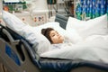 Disabled little boy lying sick in hospital bed Royalty Free Stock Photo