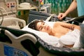 Disabled little boy lying sick in hospital bed Royalty Free Stock Photo