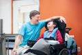 Disabled little boy in wheelchair talking with father in hospital room Royalty Free Stock Photo