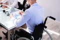Disabled Manager Sitting With His Colleagues Royalty Free Stock Photo