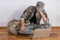 Disabled male veteran sitting and praying. He is wearing military uniform