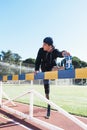 Disabled man athlete stretching with leg prosthesis. Paralympic Sport Concept.