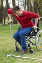 Disabled man on crutches in garden Royalty Free Stock Photo