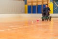 Disabled man on an electric wheelchair playing sports, powerchair hockey. IWAS - International wheelchair and amputee