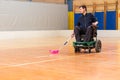 Disabled man on an electric wheelchair playing sports, powerchair hockey. IWAS - International wheelchair and amputee Royalty Free Stock Photo