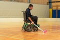 Disabled man on an electric wheelchair playing sports, powerchair hockey. IWAS - International wheelchair and amputee